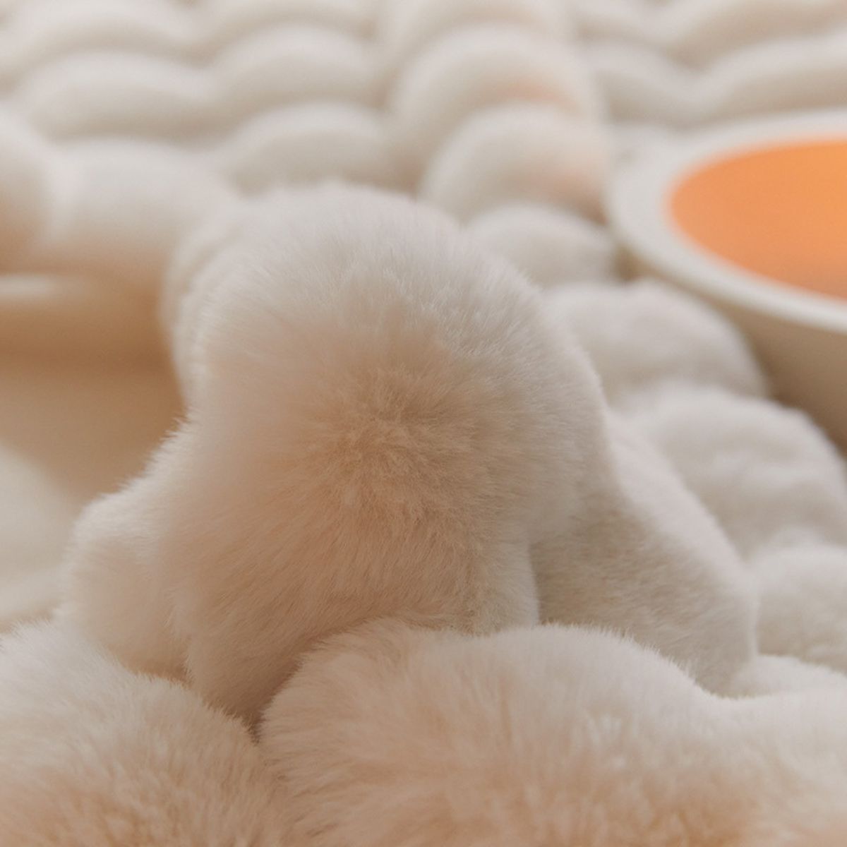 Close-up of ultra-soft bubble fleece texture in cream color