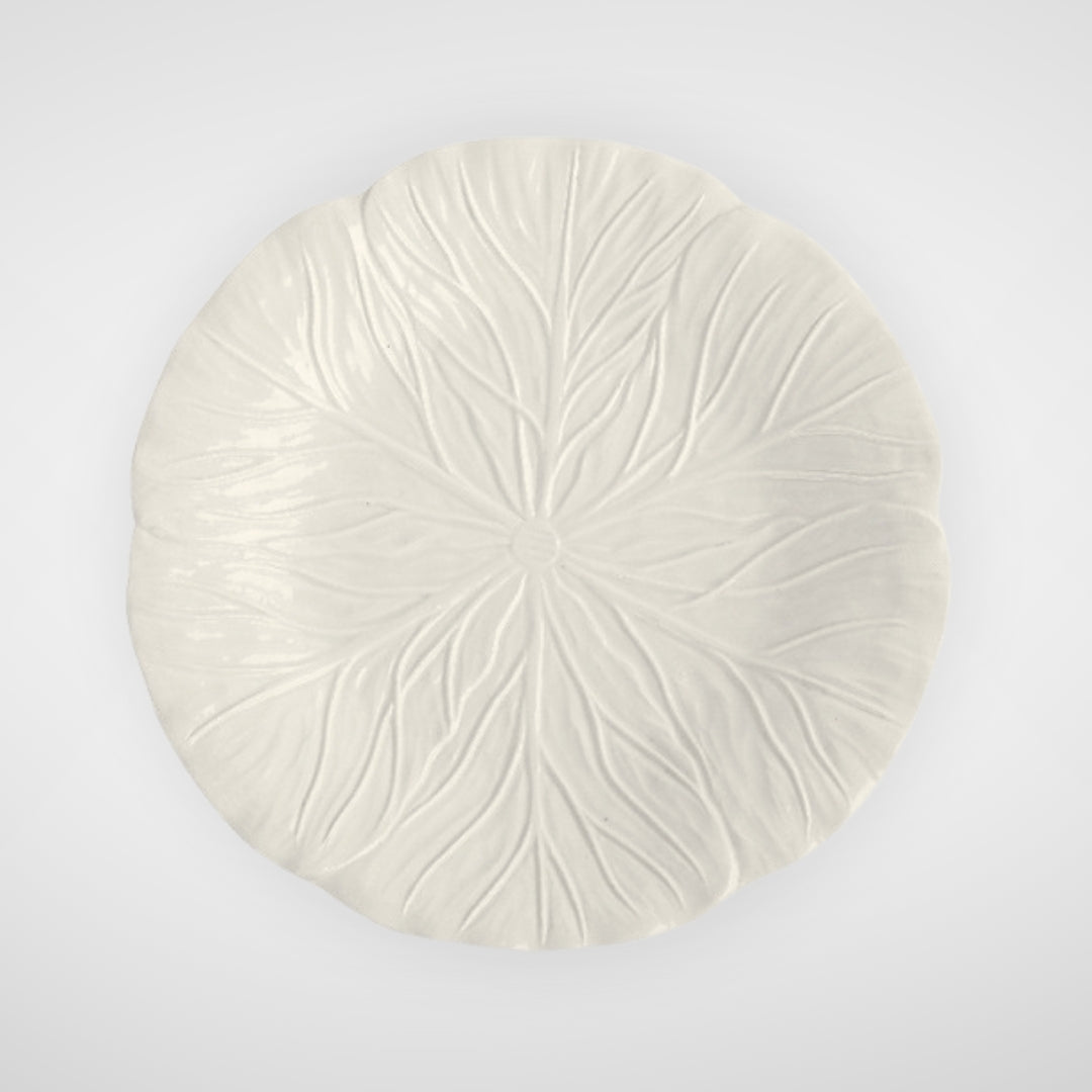 White ceramic plate with leaf texture, top view on plain background