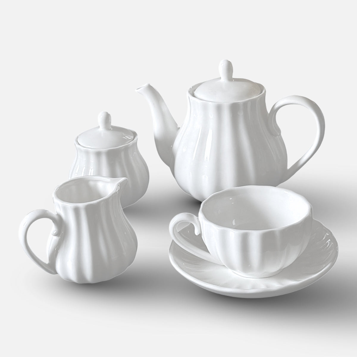 NAN GUA ceramic tea and coffee set including teapot, milk jug, sugar jar, and cup with saucer.