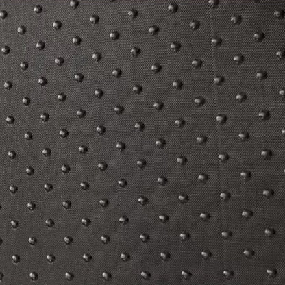  A close-up shot of the non-slip dotted texture on the bottom of a pet bed, highlighting its anti-skid safety feature.