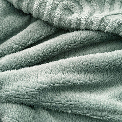 Plush sage fleece surface with embossed pattern in soft lighting