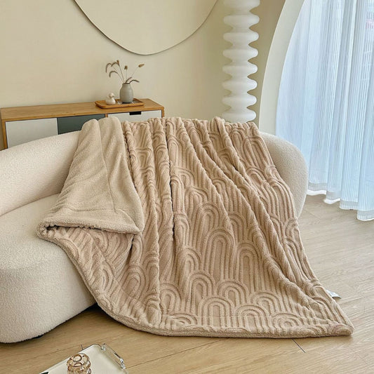 Folded textured beige throw blanket with cozy fleece backing