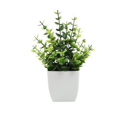 Artificial potted plant with small green leaves in white pot for home or office decor