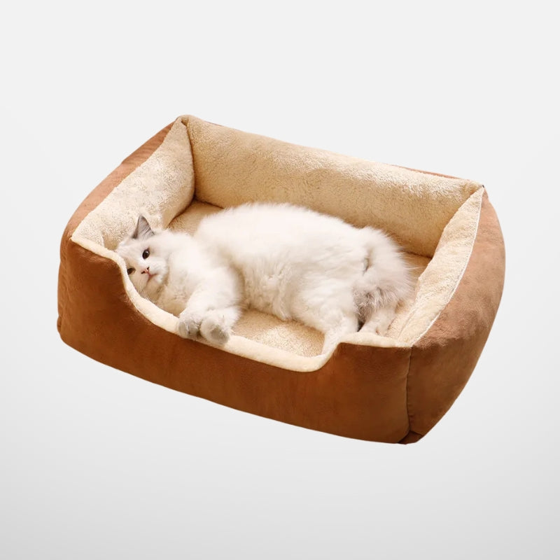  A relaxed white cat resting inside a plush brown pet bed, showcasing the product's comfort and inviting design.