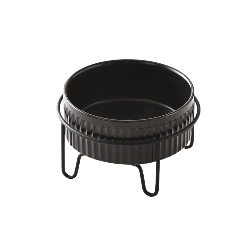 Black ceramic pet bowl placed in a raised metal stand for ergonomic feeding.