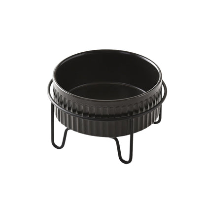 Black ceramic pet bowl placed in a raised metal stand for ergonomic feeding.