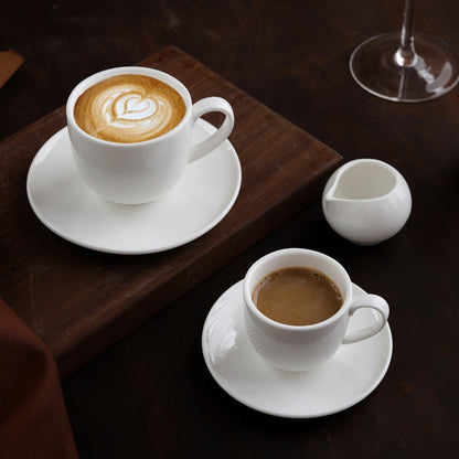 CAI ceramic coffee set styled on dark wood table with cappuccino and espresso.