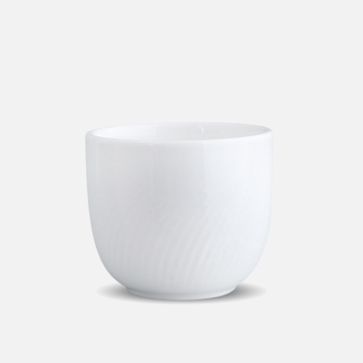 CAI small porcelain cup with subtle swirl texture, isolated view.