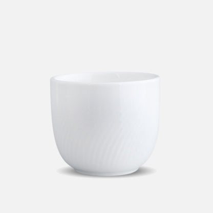 CAI small porcelain cup with subtle swirl texture, isolated view.