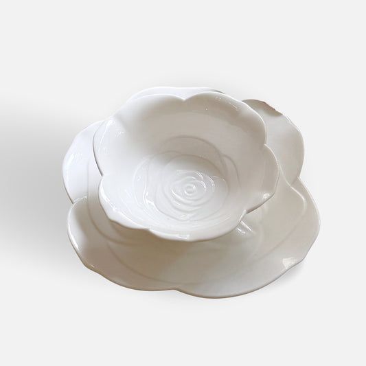 Matching ceramic tea cup and rose-shaped plate, elegantly displayed.