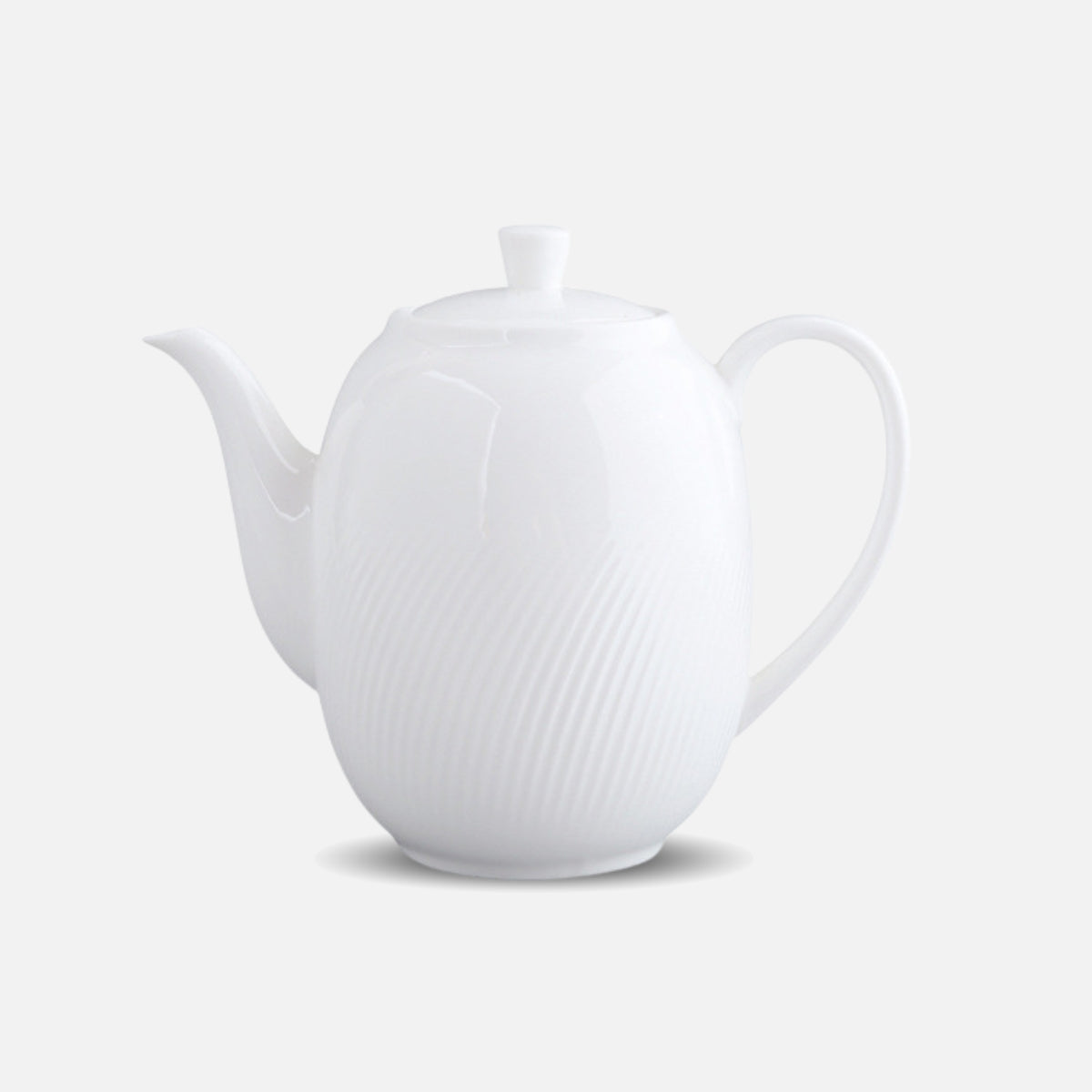 CAI white ceramic teapot with curved handle and lid, studio shot.