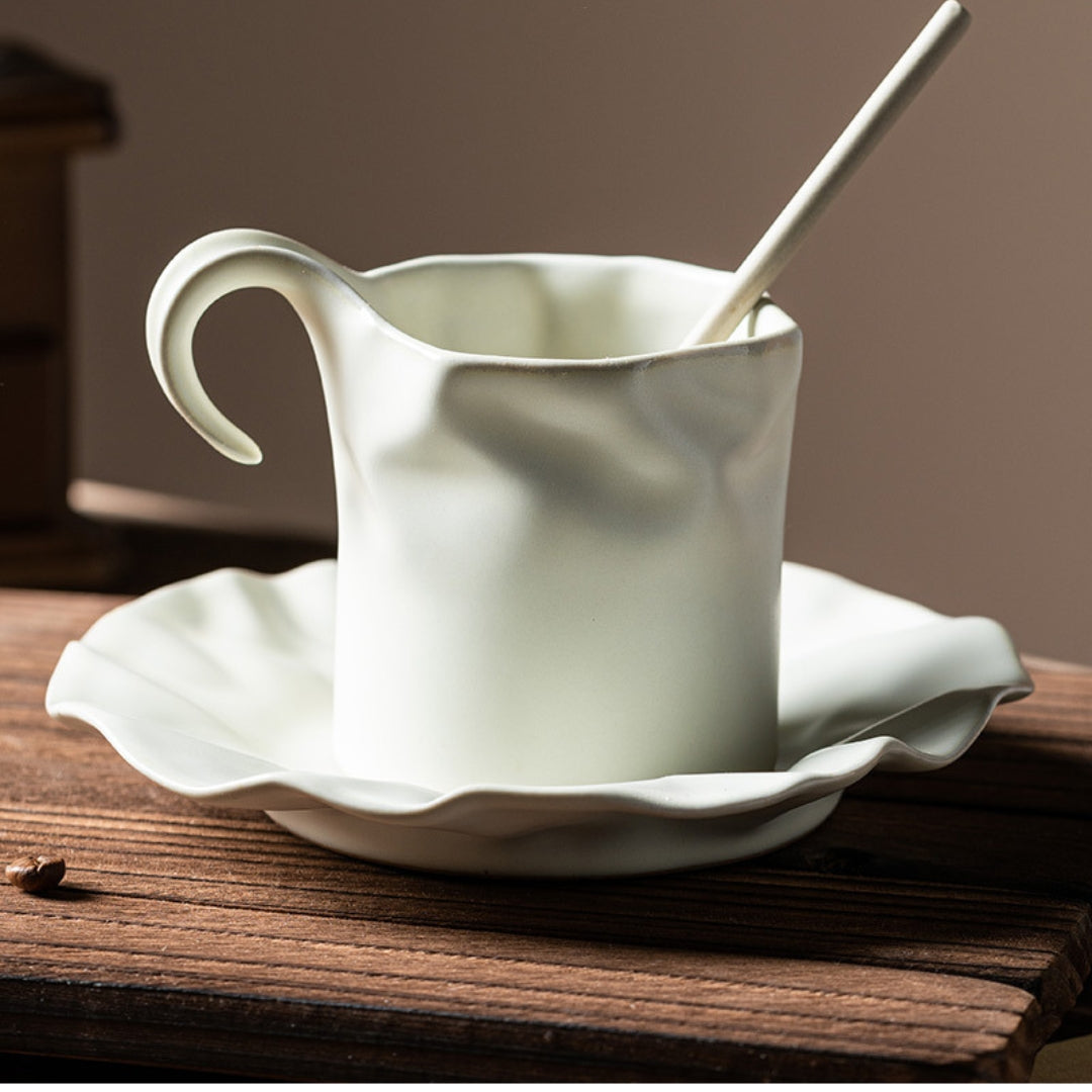 Elegant ceramic coffee cup with organic curves, styled in soft lighting.
