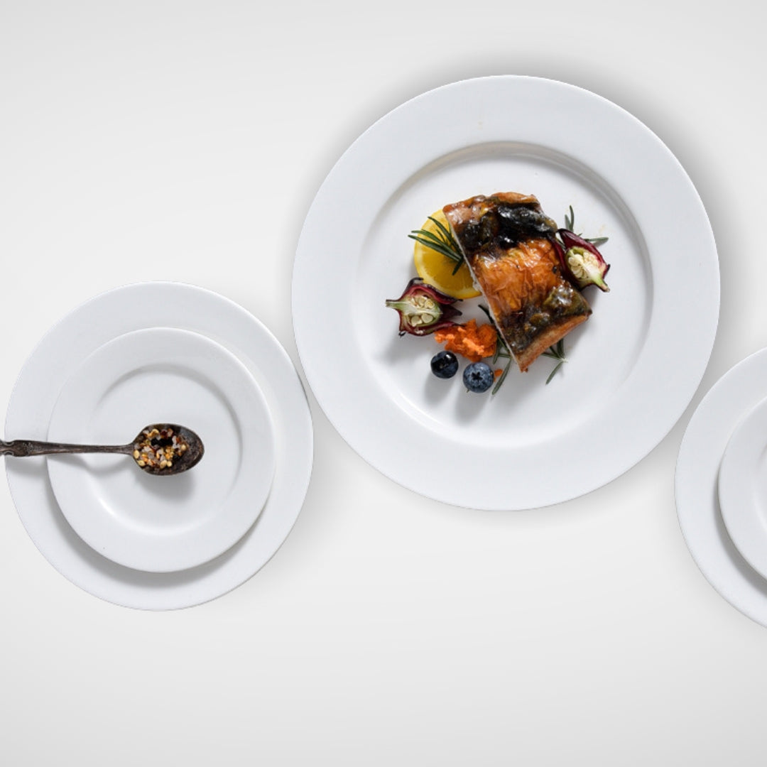 Three white plates with different food arrangements, top view