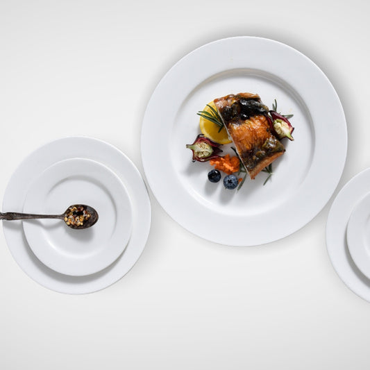 Three white plates with different food arrangements, top view