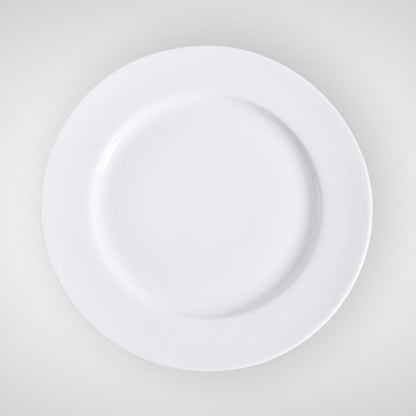 Minimalist white ceramic plate, top view on light background