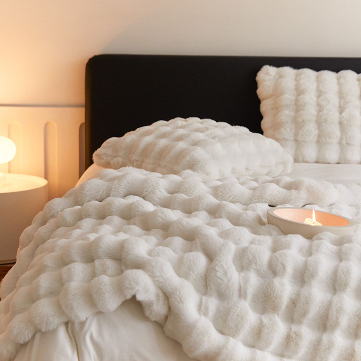 Cream fleece blanket and pillow set styled on modern bed