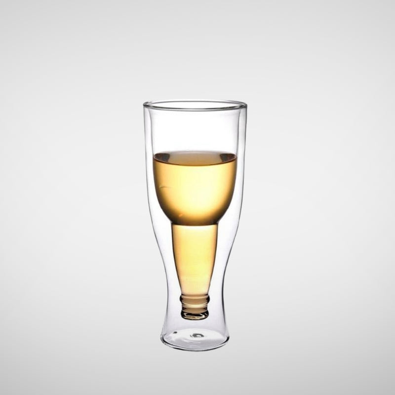 A close-up shot of a unique double-wall glass with a beer bottle shape inside, filled with a light-colored beer.
