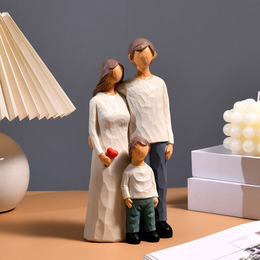A lifestyle photo of the family figurine displayed as home decor on a wooden desk, next to a modern lamp and decorative boxes.