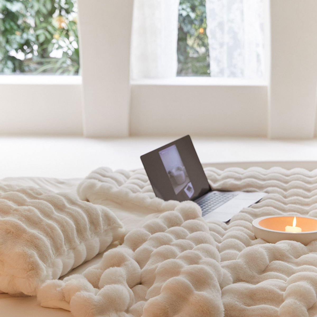 Fleece blanket set with pillow and candle, laptop scene by window