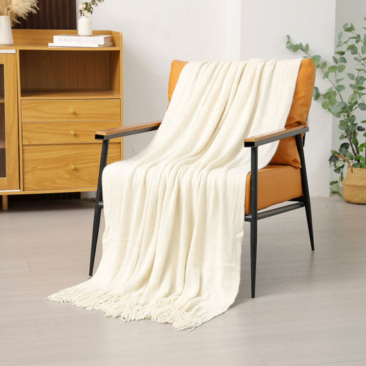 Cream throw blanket draped on orange chair in cozy living room