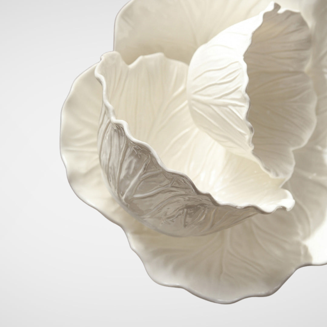 Close-up of nested white ceramic lettuce bowls, glossy finish