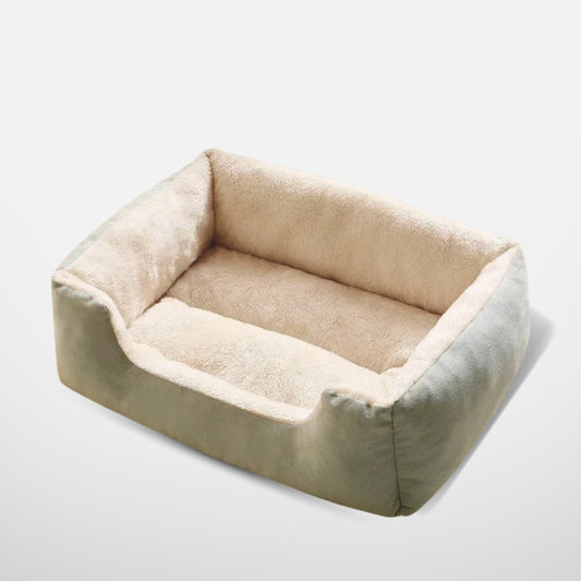  A product shot of a mint green rectangular plush pet bed with a cozy beige interior, isolated against a neutral background.