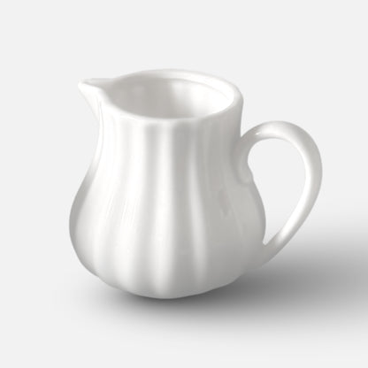 NAN GUA ceramic milk jug with fluted body and minimalist spout design.