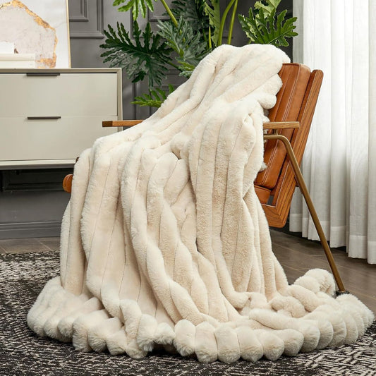 Blanket draped over leather chair in cream