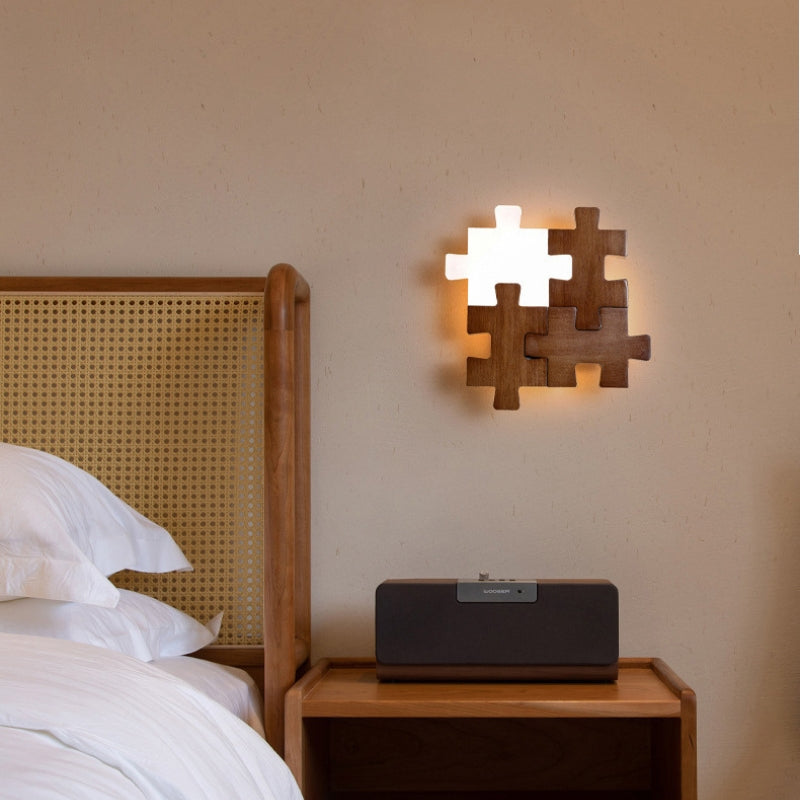 Puzzle shape wooden wall sconce lamp mounted beside bed