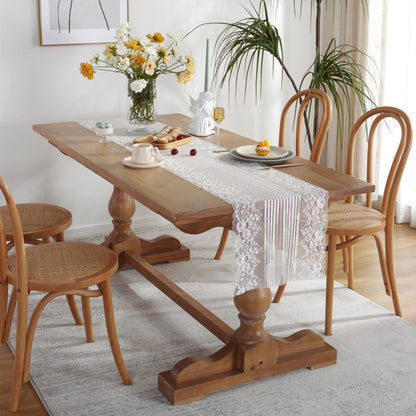 Lace table runner on wooden table with floral arrangement
