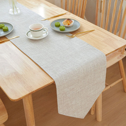 Light grey table runner with plates and tea