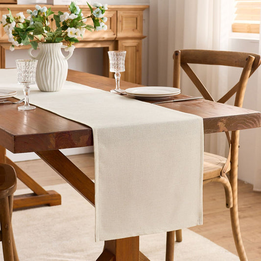 Side view of natural table runner draped on wooden table