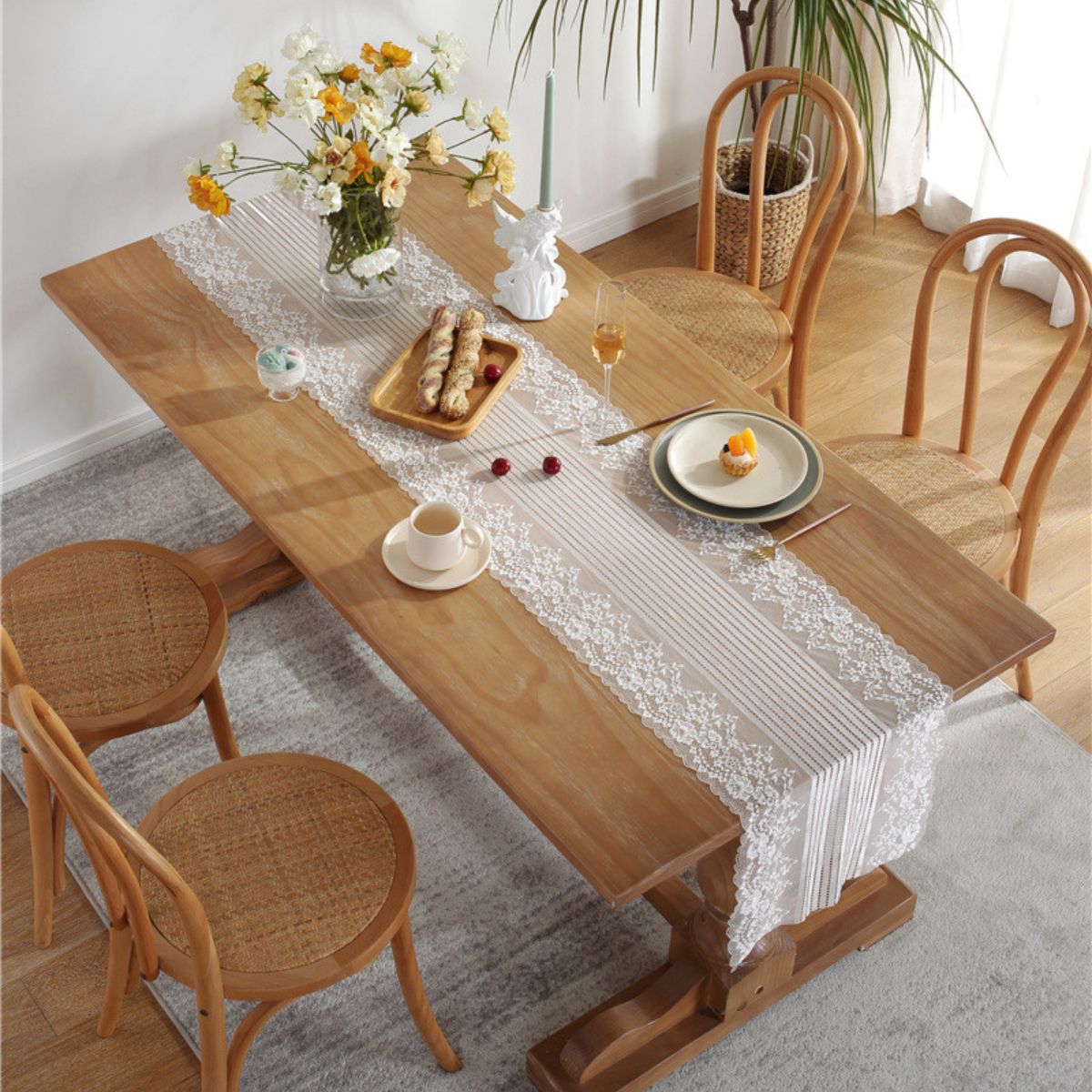 Top view of lace table runner on dining table with food setting