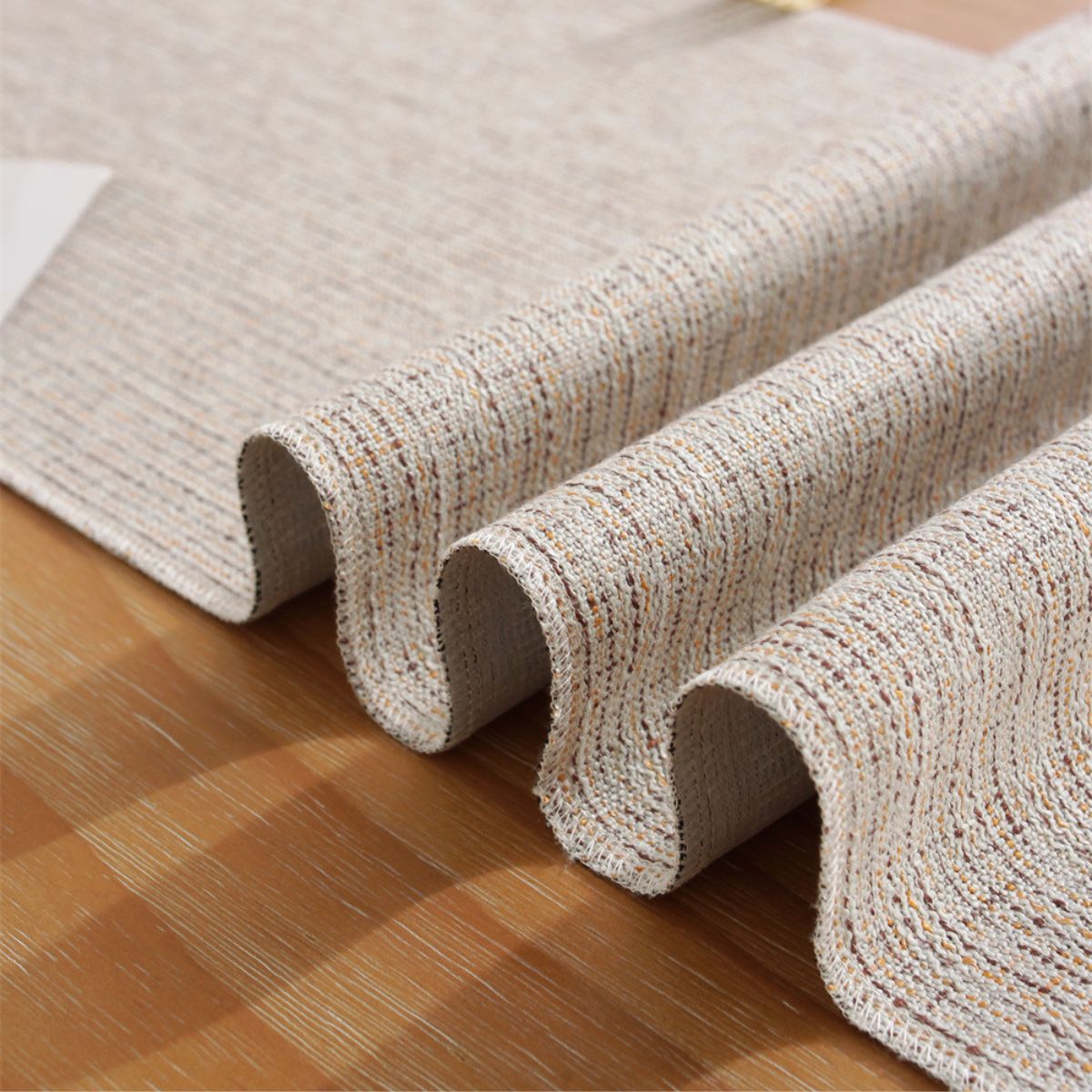 Close-up of textured woven fabric and tassel detail