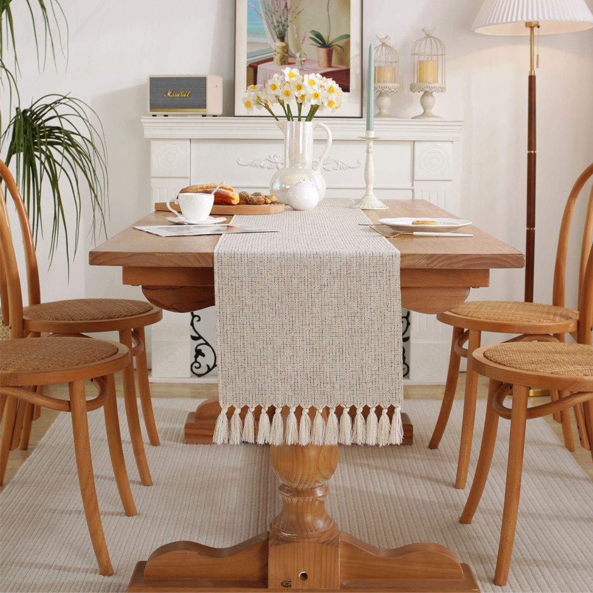 Dining room with woven tassel table runner on rustic table