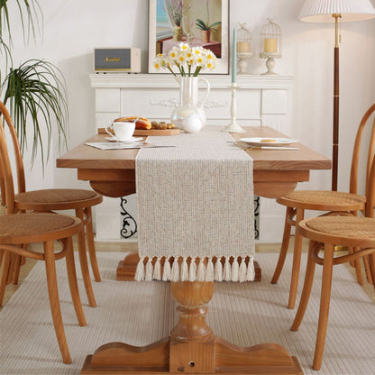 Dining room with woven tassel table runner on rustic table